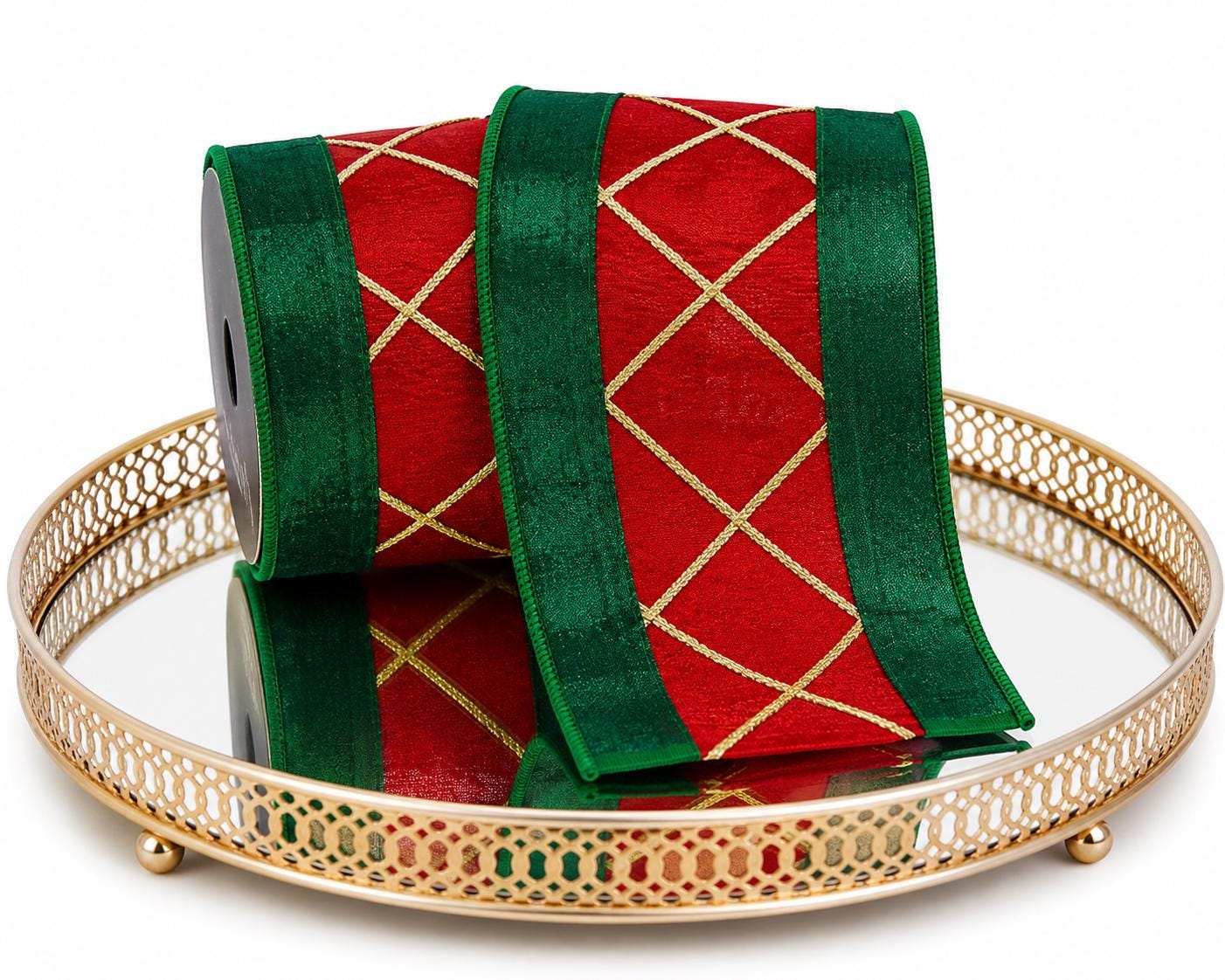 Red green and gold lattice Christmas ribbon displayed on a decorative gold mirrored tray