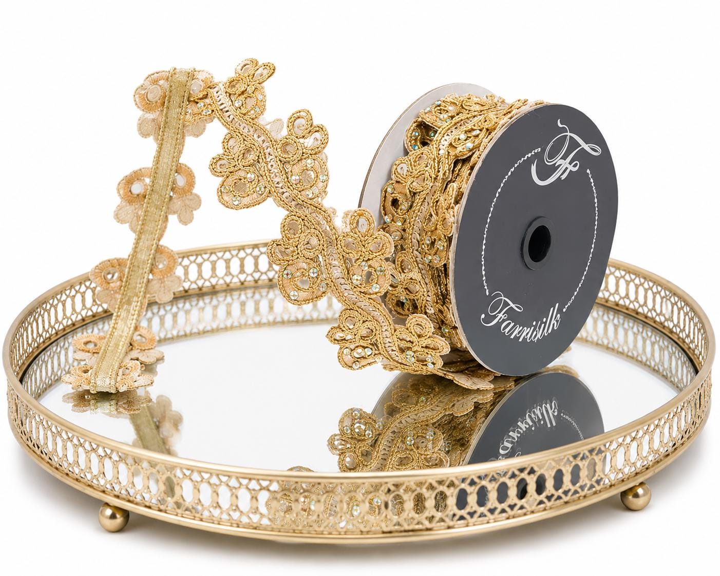 Gold Jeweled Wired Ribbon on a mirror with a reflection of the ribbon.